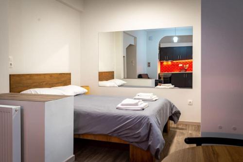 a bedroom with a bed with two towels on it at Studio Apartment next to Alsos Ilision in Athens