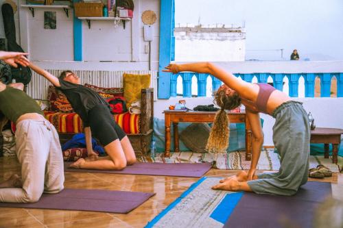 a group of people doing yoga in a room at Onda Surf in Taghazout