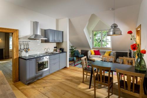 a kitchen and living room with a table and a stove at Podenhaus in Bad Aussee