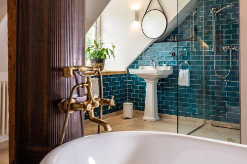 a bathroom with a tub and a sink at Podenhaus in Bad Aussee