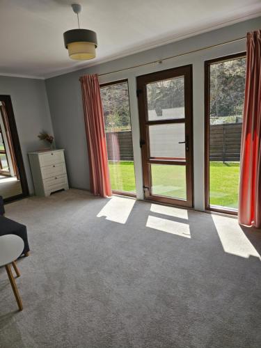 an empty living room with sliding glass doors at Relax and Smile Rameț in Biceşti