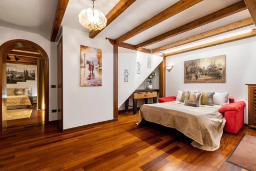 リード・ディ・ヴェネツィアにあるDante's Residenceのベッドルーム1室(ベッド1台、赤いソファ付)