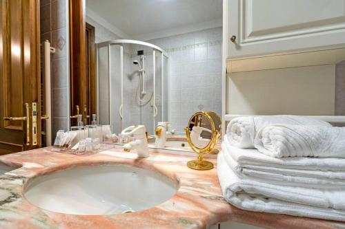 a bathroom with a marble sink and a shower at Dante's Residence in Venice-Lido
