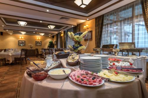 a buffet of food on a table in a restaurant at Evelina Palace Hotel in Bansko