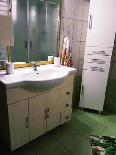 a bathroom with a sink and a mirror at The Sunny House in Kritharia