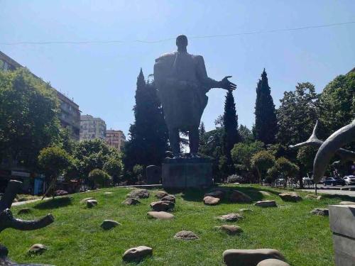 a statue of a man standing in a field at Peaceful apartment in the central area in Tbilisi City