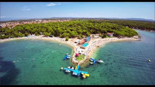 a group of people on an island in the water at Apartments Classic#BnM in Biograd na Moru