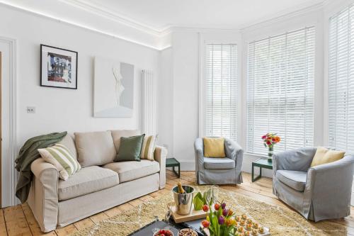 a living room with a couch and two chairs at Hoe Park House, Sleeps 10, Historic, Central, Near Excellent Dining, Bars & Seafront in Plymouth