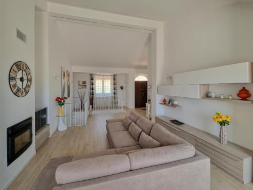 a living room with a couch and a fireplace at Villa Rosa in Latronico