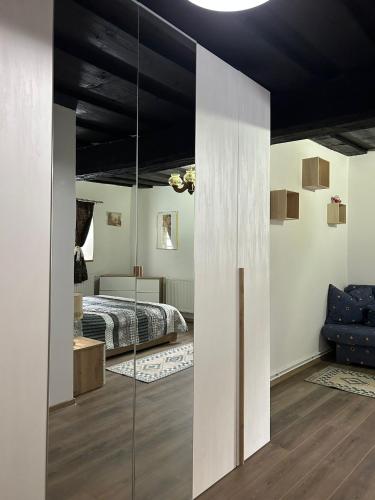 a bedroom with a bed and a glass wall at Blue House in Ramingstein