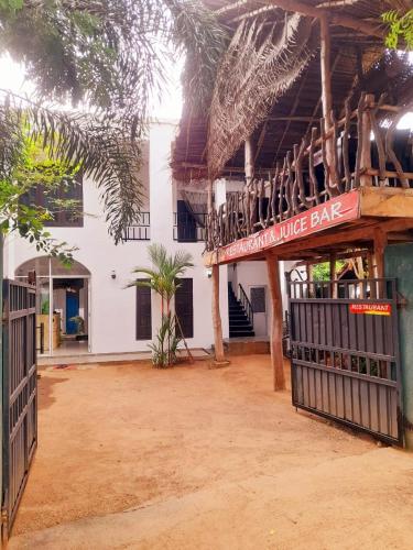 a building with a bar in the middle of a courtyard at Heritage Rangiri Villa in Dambulla