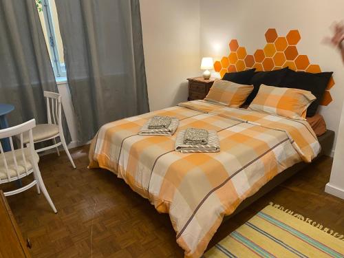 a bedroom with a bed with two towels on it at Barão 35 Guest House in Braga