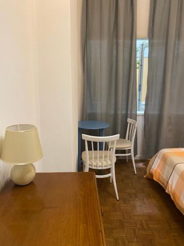 a bedroom with a bed and a table and chairs at Barão 35 Guest House in Braga