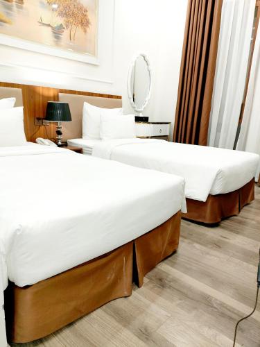 Ένα ή περισσότερα κρεβάτια σε δωμάτιο στο Halong Lavender Hotel