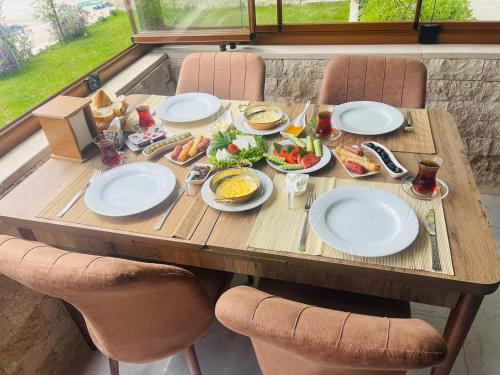 a wooden table with plates of food on it at Sirius Boutique Hotel Pamukkale in Pamukkale