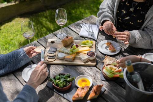 a group of people sitting around a picnic table with food at The Griffin Inn in Fletching