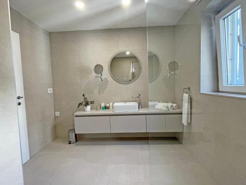 a bathroom with a sink and a mirror at Villa Ardura - island holiday residence **** Bol. Island Brač in Bol