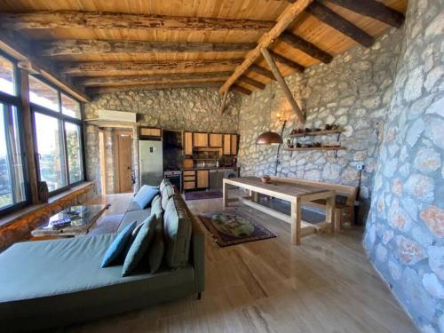 a bedroom with a bed and a stone wall at 19th Century Neo-Modern KABAK VALLEY STONE HOUSE in Fethiye