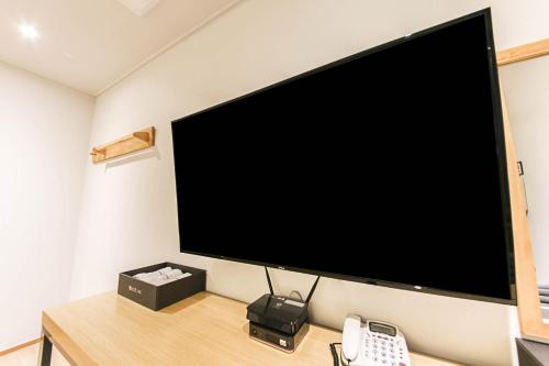 a large flat screen tv hanging on a wall at 어라연 관광호텔 영월 in Yeongwol