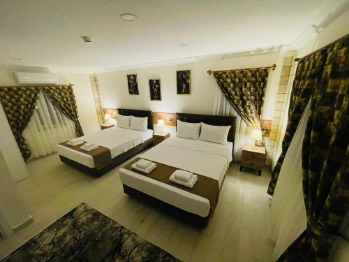 a large room with two beds and a couch at Sirius Pamukkale in Pamukkale