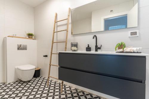 a bathroom with a sink and a toilet at Agrippas St 8 - Isrentals in Jerusalem