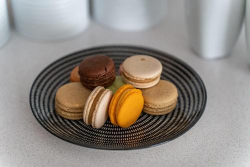 a plate of cookies and macaroons on a counter at Agrippas St 8 - Isrentals in Jerusalem