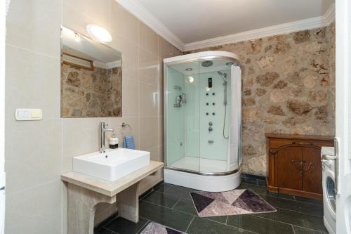 a bathroom with a sink and a shower at Villa ANATOLIAN in Antalya