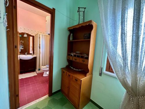 a bathroom with a sink and a toilet and a mirror at Sea Pearl in Casteldaccia