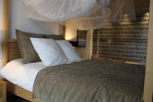 a bedroom with a large bed with white pillows at Loft Rural Cirueches 19 in Carabias