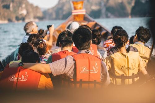 a group of people in a boat on the water at Panvaree Resort in Ratchaprapha