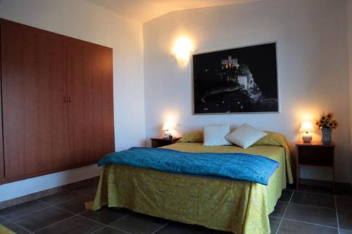 a bedroom with a bed with two lamps on it at Villa Del Conte in Drapia