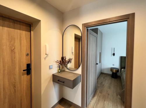 a bathroom with a sink and a mirror at Cozy family apartment near the old town in Klaipėda