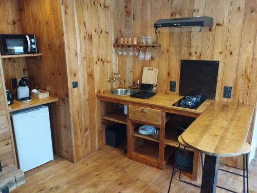 a kitchen with a wooden desk and a sink at Spa Mensignac in Mensignac