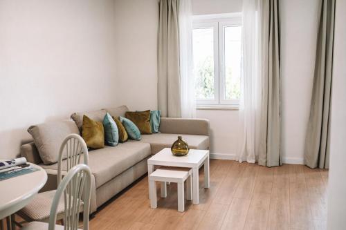 a living room with a couch and a table at Villa Ardura - island holiday residence **** Bol. Island Brač in Bol