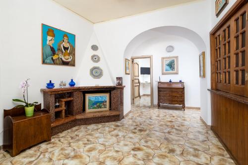 a living room with a fireplace and a wooden door at A casa di Antonio in Positano
