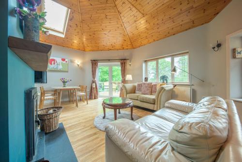 a living room with a couch and a table at The Old Rectory Donard in Dún Ard