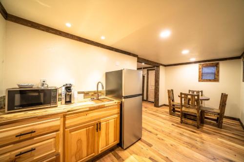 a kitchen with a refrigerator and a table and chairs at St. Elmo Hotel in Ouray