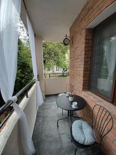 a patio with a table and chairs on a balcony at Tara Deluxe Apartment in Varna City