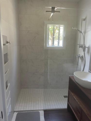 a bathroom with a shower and a sink at Les Terrasses des Gardies in Pignan