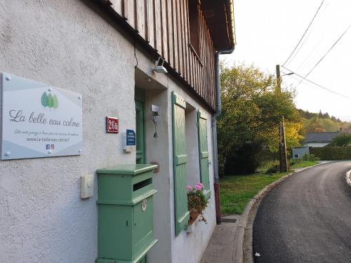 a building with a sign on the side of a street at Gîte 4 étoiles La Belle Eau Calme in Futeau