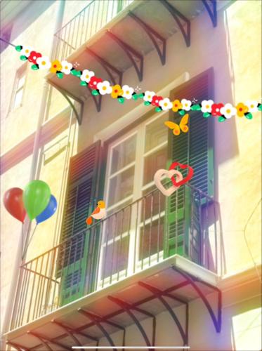 a balcony with a bunch of balloons and a garland at Elisir house in Palermo