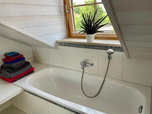 uma banheira na casa de banho com uma janela em Bergblick em Weilheim in Oberbayern