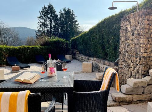 a table with glasses of wine on a patio at Hotel Am Hirschhorn - Wellness - Spa - and more in Wilgartswiesen