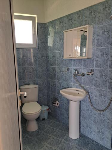 a bathroom with a toilet and a sink at Villa Veneta in Sinemorets