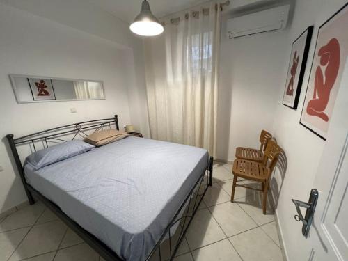 1 dormitorio con 1 cama y 1 silla en Elegant studio by the beach in Ireon, en Iräon