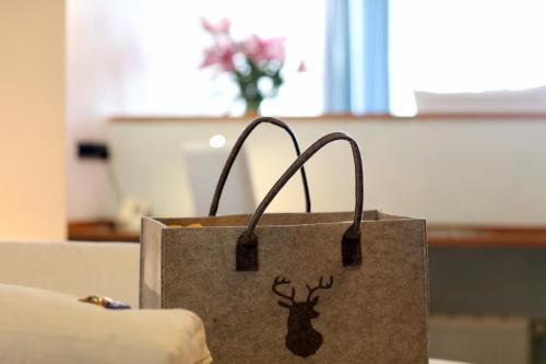 a shopping bag with a picture of a deer on it at Hotel Am Hirschhorn - Wellness - Spa - and more in Wilgartswiesen