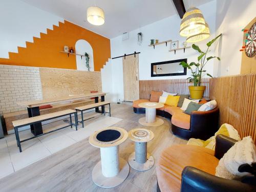 a living room with a couch and a table at COAST - Utopy Hostel in Biarritz