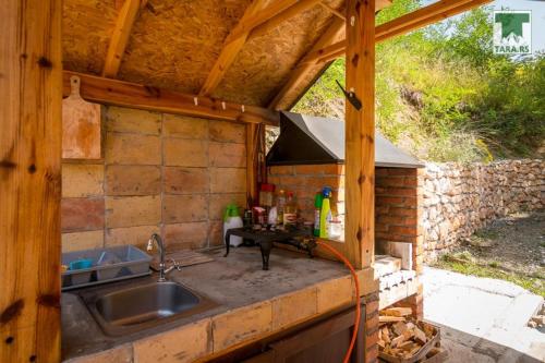 a kitchen with a sink and a stove at Air Zaovine in Bajina Bašta