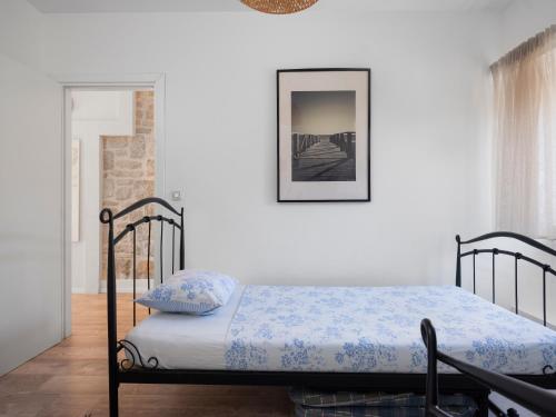 - une chambre dotée d'un lit avec des draps bleus et blancs dans l'établissement Hanna Cozy Old Stone House, à Murter