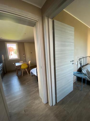 a room with a door leading to a dining room at Sala dell Estate Guest House in Secchia